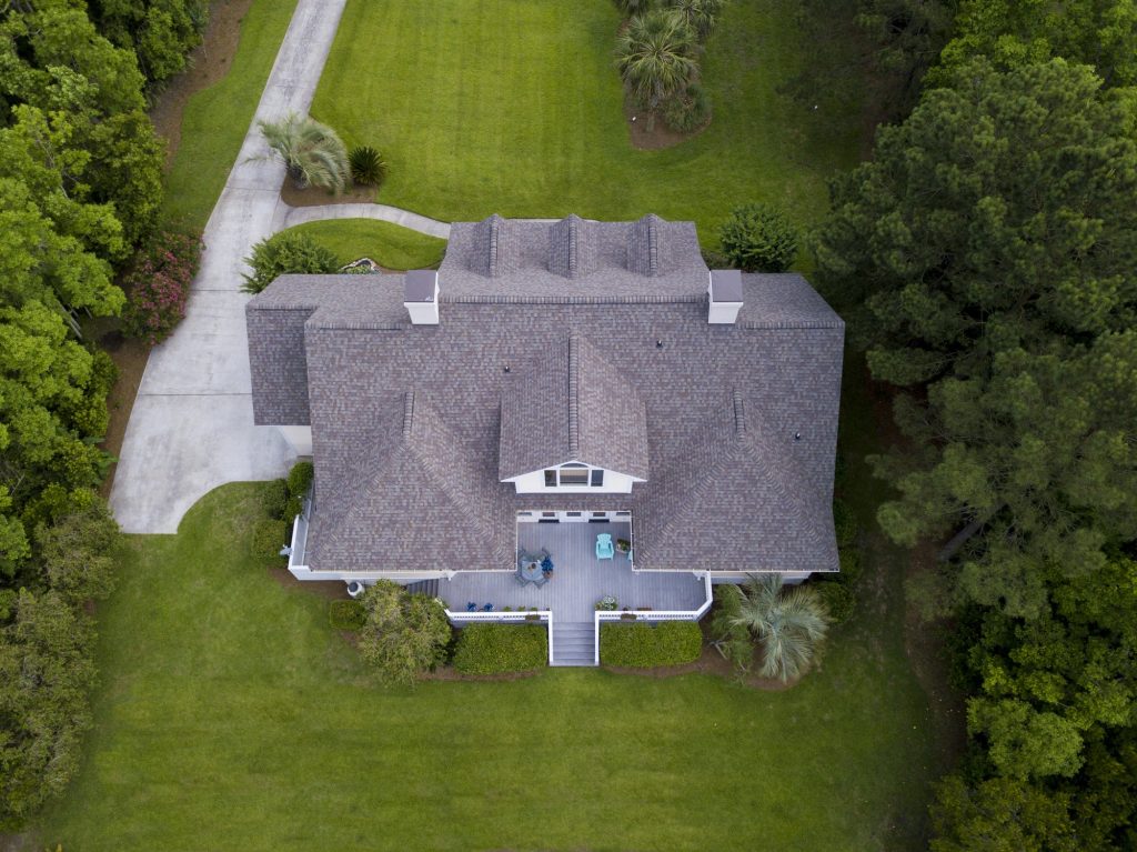 waco Aerial view of large home with new roof on beautiful property.